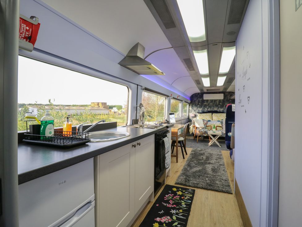 A kitchen with countertops and appliances at Paddington Railway Carraige 2 with hot tub in Ely