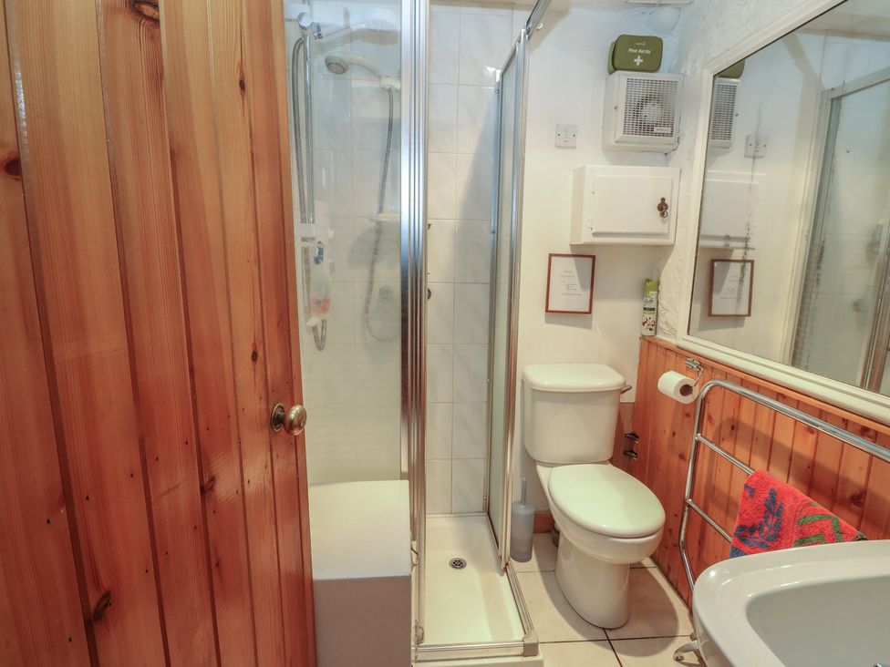 A bathroom with a shower, toilet, and sink at 4 Whiterow Kentallen near Ballachulish