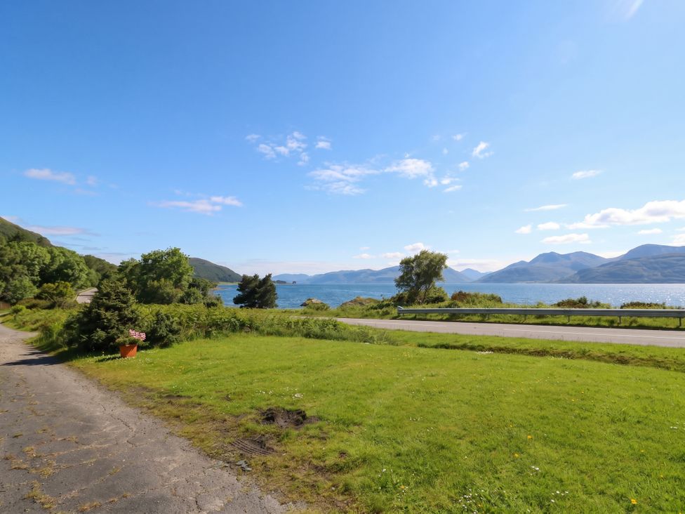 A view of water and mountains near a road at 4 Whiterow Kentallen near Ballachulish