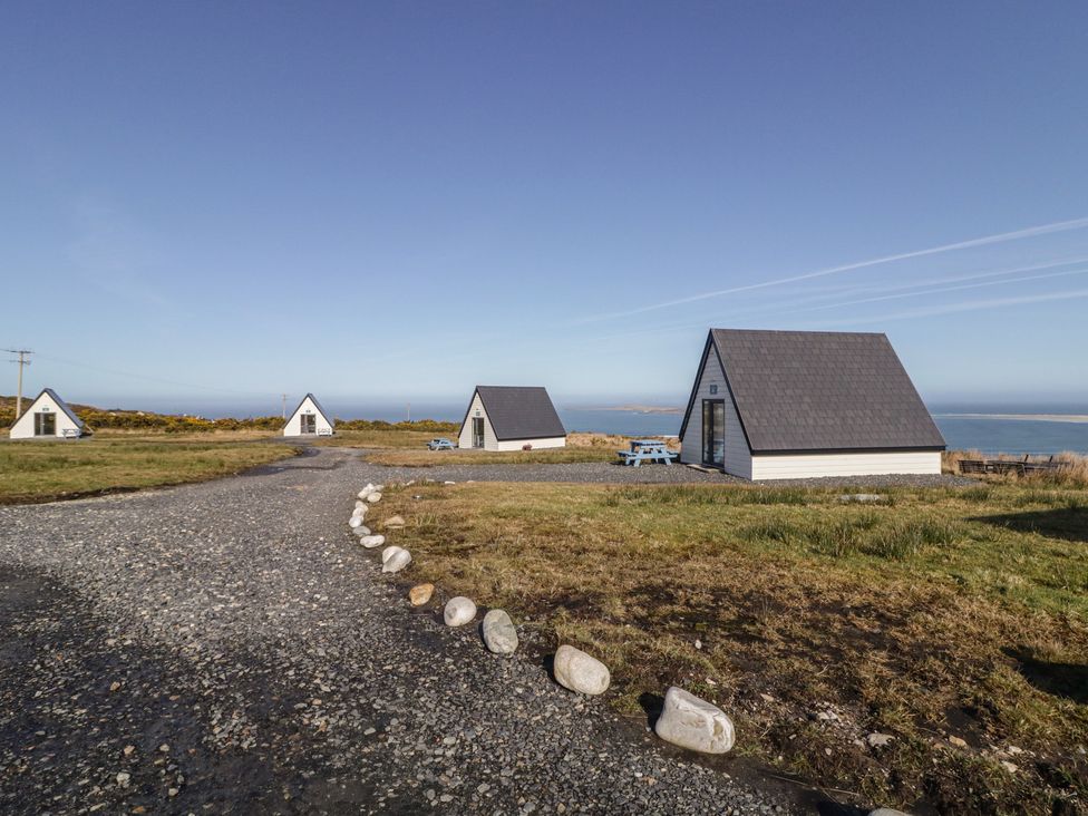 An outdoor area with cabins and a gravel path at Cabin 4 Doire Chonair in Gortahawk