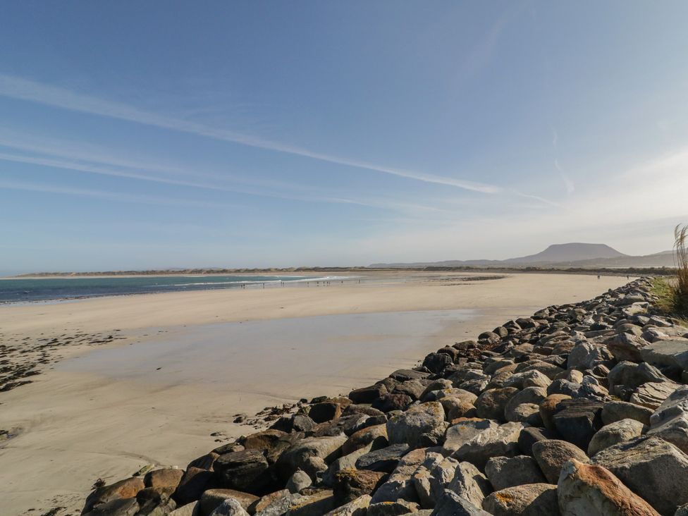 A beach with rocks and water at Cabin 4 Doire Chonair in Gortahawk