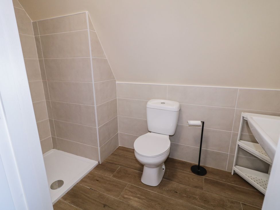 A bathroom with a toilet and shower at Cabin 5 Eargail in Gortahawk