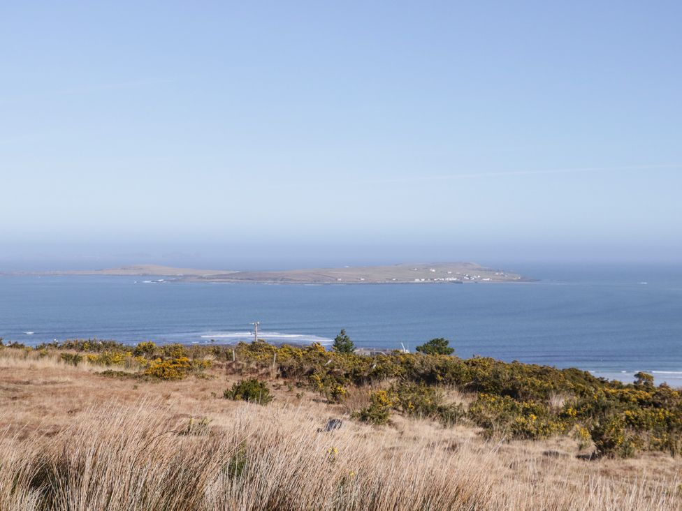 A coastal view of an island and sea at Cabin 6 An Mhucais in Gortahawk