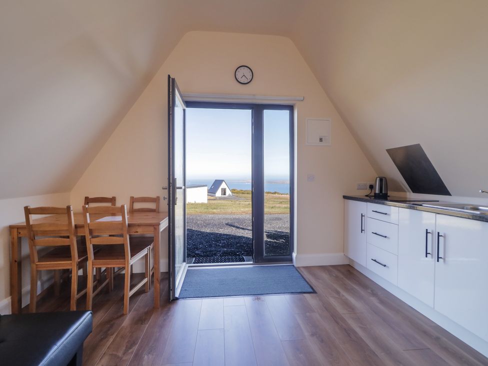 A kitchen with a table and chairs at Cabin 8 Inish Dumhaigh Gortahawk