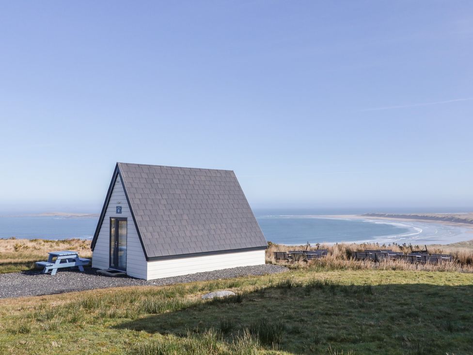 A cabin with a slate roof overlooking the ocean at Cabin 10 Inish Bo Finne in Gortahawk