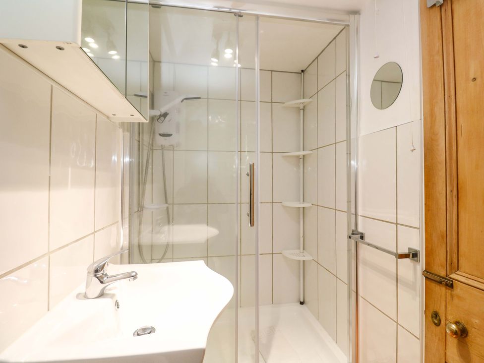 A bathroom with a sink and a shower at St. Dominic Cottage in St. Ives