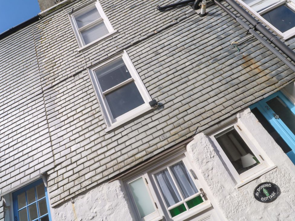 A building facade with windows and a door at St. Dominic Cottage in St. Ives