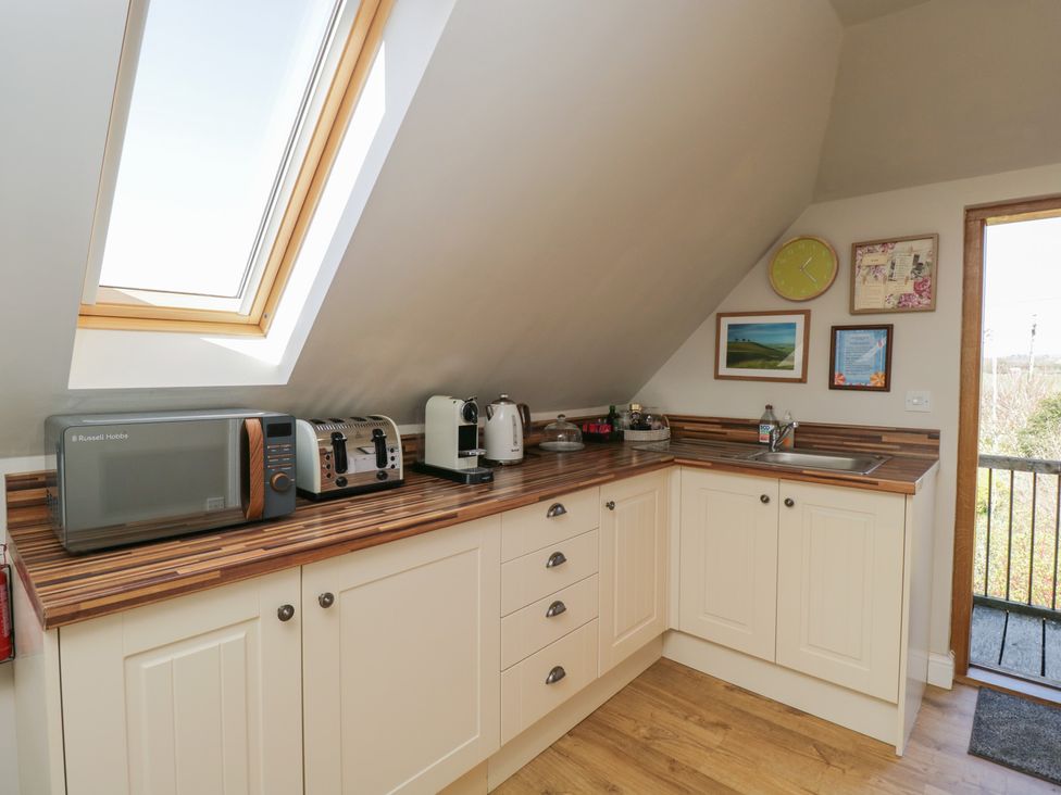 A kitchen with appliances and countertop at The Hideaway Loft in Chippenham