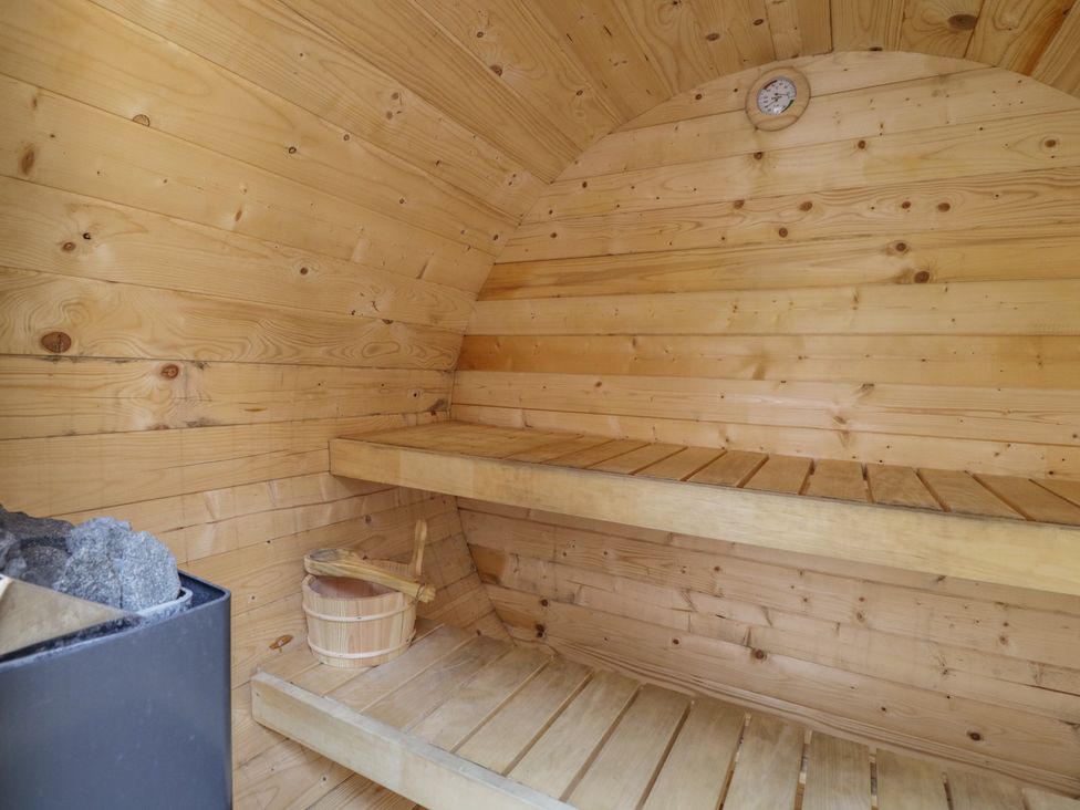 A sauna with wooden walls and shelves at The Hideaway Loft in Chippenham