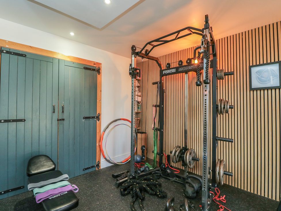 A gym with exercise equipment and storage at The Hideaway Loft in Chippenham