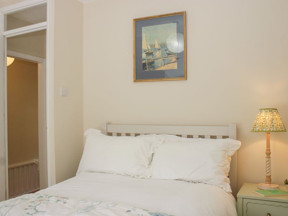 A bedroom with a bed and a bedside table at Upper Frogpool Cottage in Crediton