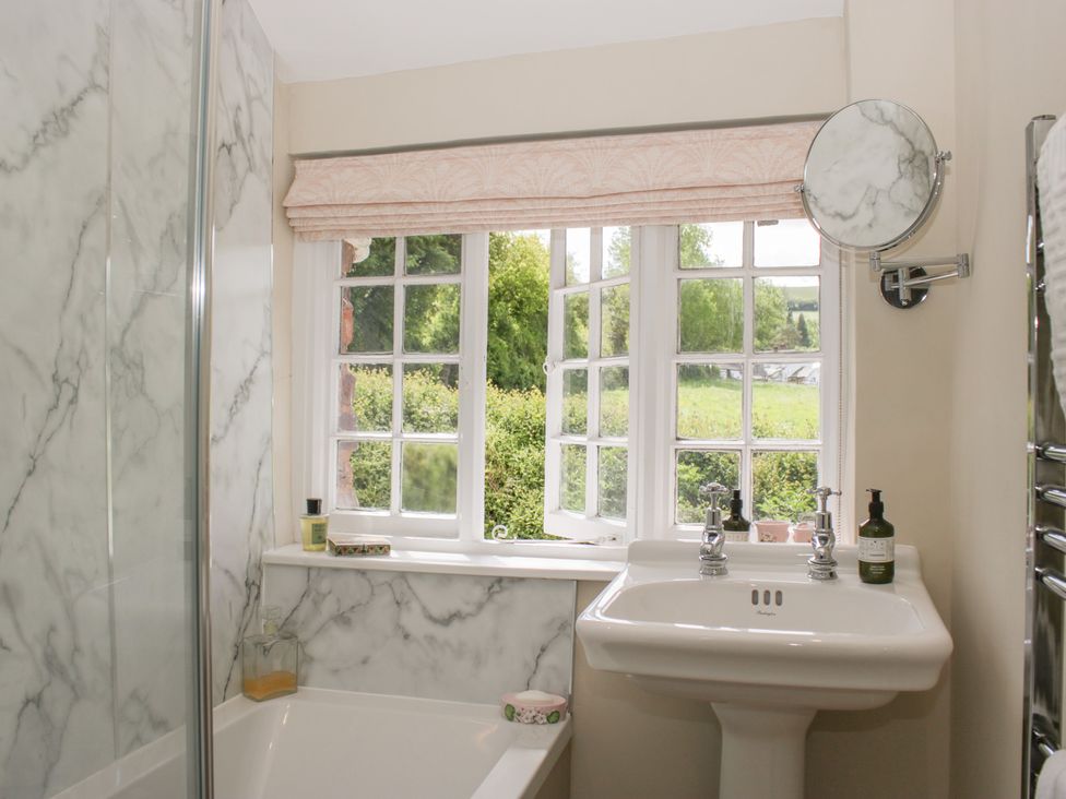 A bathroom with a sink and bathtub at Upper Frogpool Cottage in Crediton