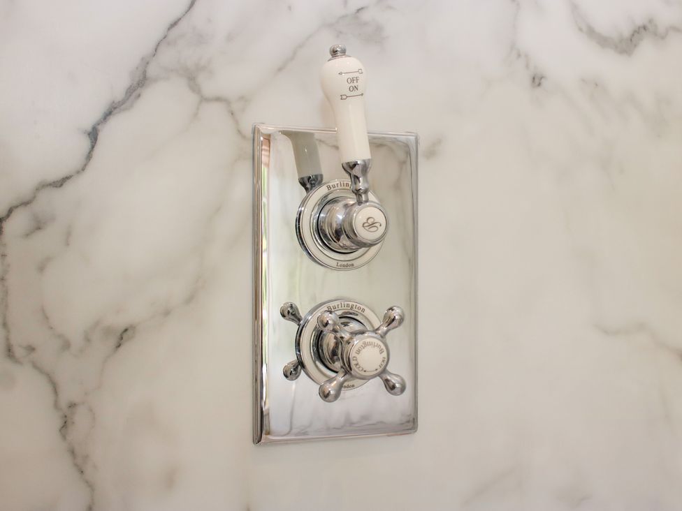 A shower control panel in a bathroom at Upper Frogpool Cottage Crediton