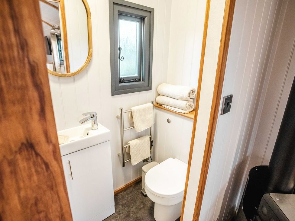 A bathroom featuring a toilet, sink, and towel rack at Shepherds View in Bradley near Ashbourne