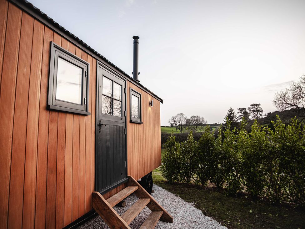 A wooden hut exterior with steps at Shepherds View, Bradley near Ashbourne