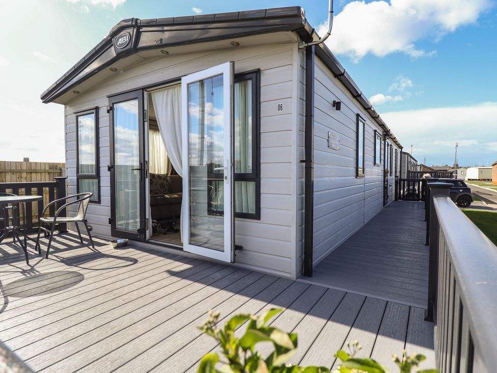 An outdoor area with table and chairs at Number 6 - Sandy Beach Holiday Park in Bacton