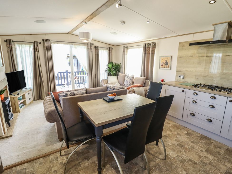 A living room with a dining table and sofa at Number 6 - Sandy Beach Holiday Park in Bacton