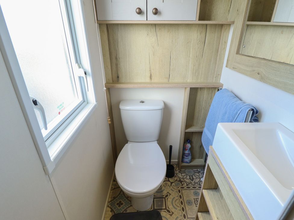A bathroom with a toilet and sink at Number 6 - Sandy Beach Holiday Park Bacton
