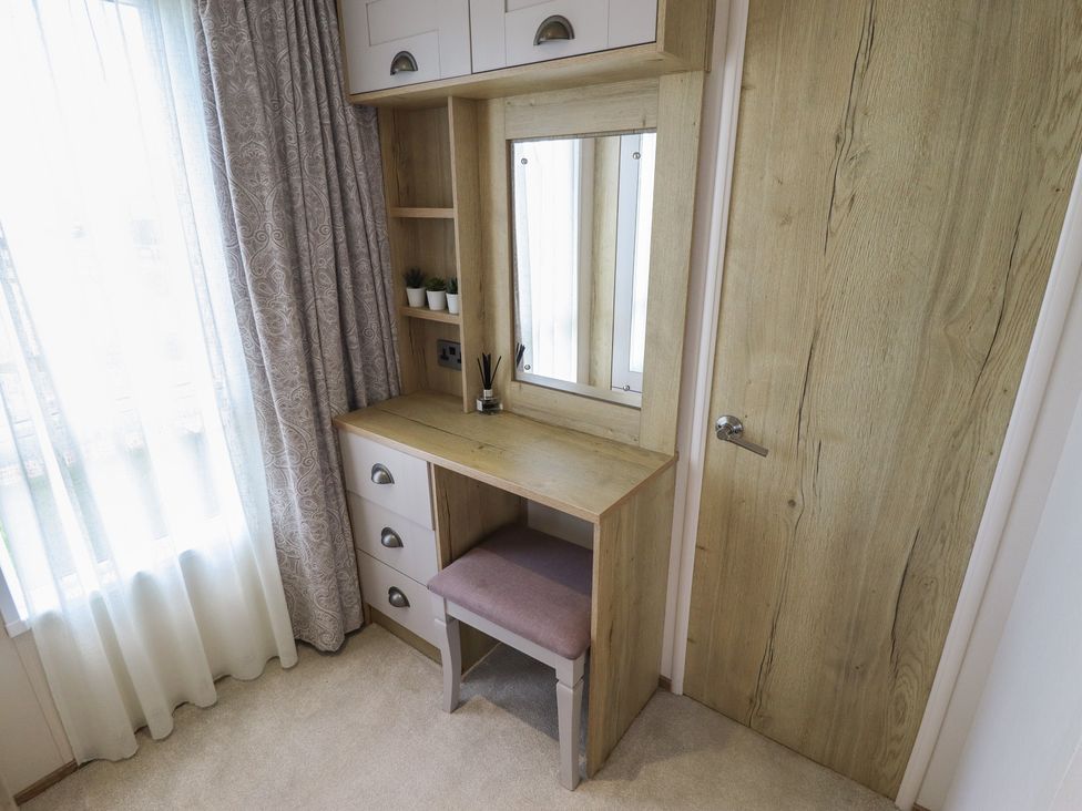 A vanity desk with a mirror and chair at Number 6 - Sandy Beach Holiday Park Bacton