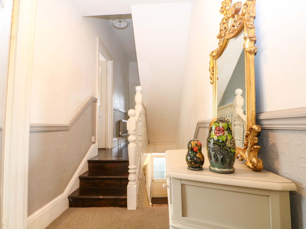A hallway with stairs and decorative items at Tickety-Boo in Broadstairs