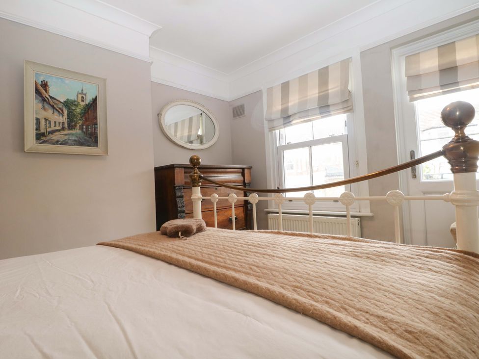 A bedroom featuring a bed, blanket, painting, and chest of drawers at Tickety-Boo in Broadstairs