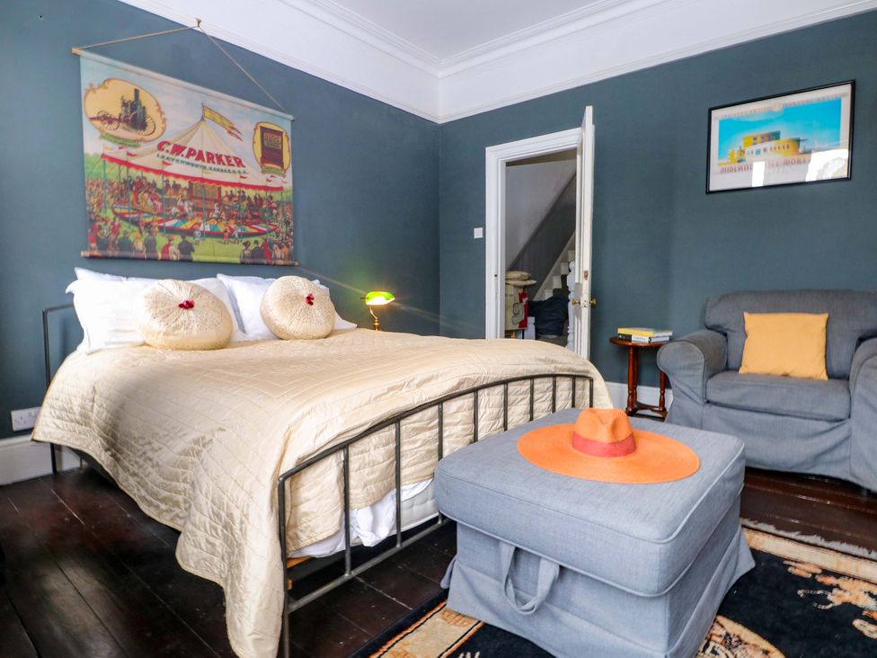 A bedroom with a bed and seating area at Tickety-Boo in Broadstairs