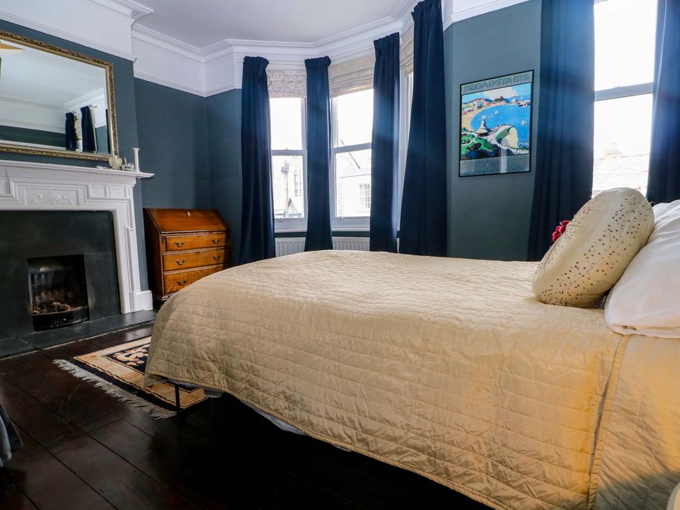 A bedroom with a bed and a fireplace at Tickety-Boo in Broadstairs