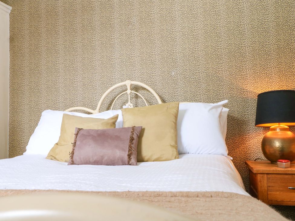 A bedroom with a bed and lamps at Tickety-Boo in Broadstairs