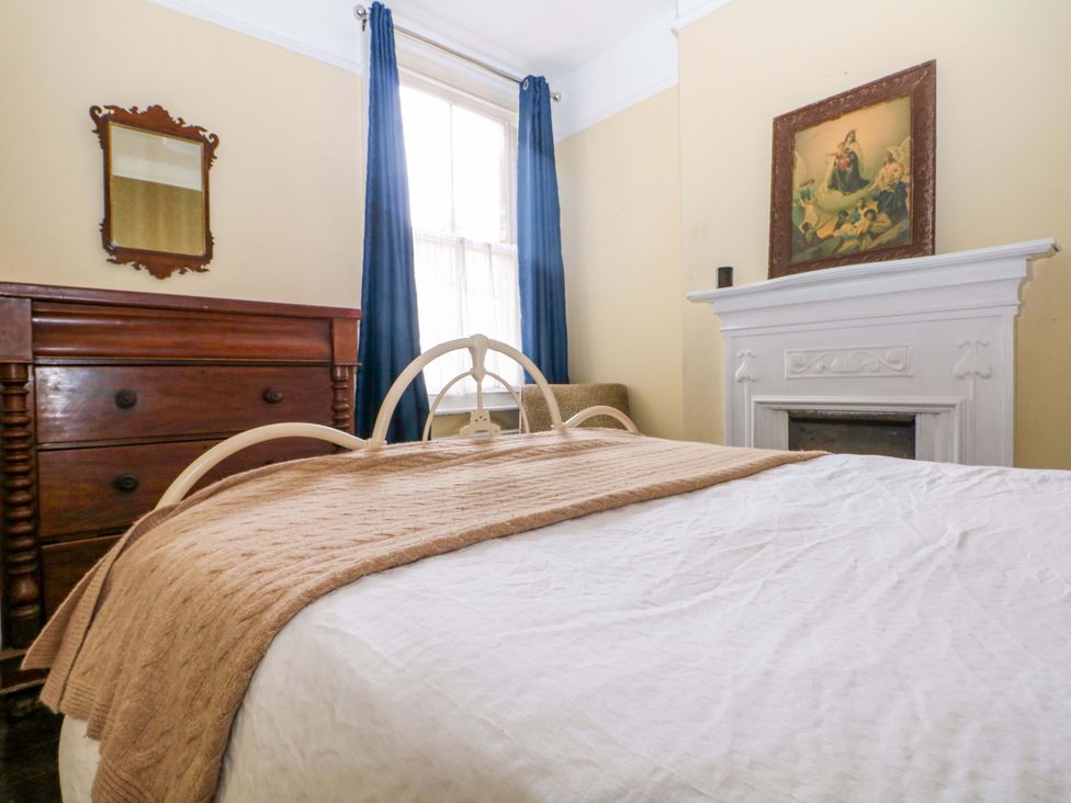 A bedroom with a bed and dresser at Tickety-Boo in Broadstairs