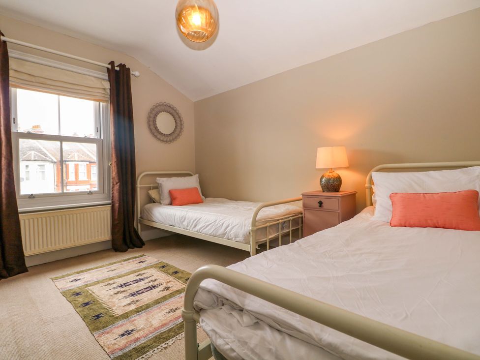 A bedroom with two beds and a window at Tickety-Boo in Broadstairs
