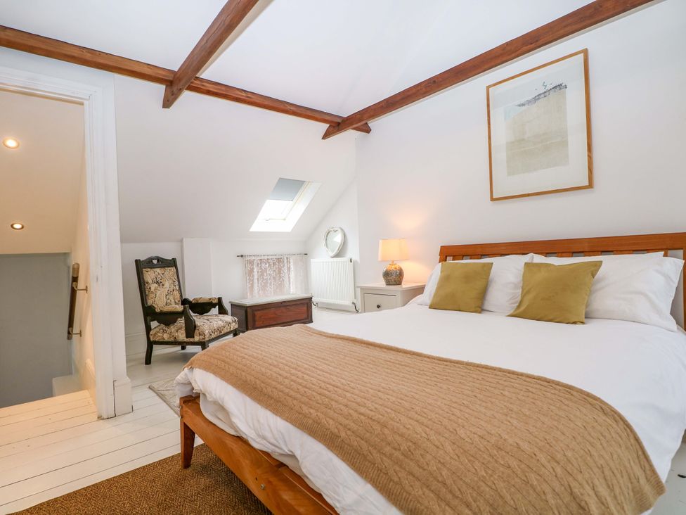 A bedroom with a bed and chair at Tickety-Boo in Broadstairs