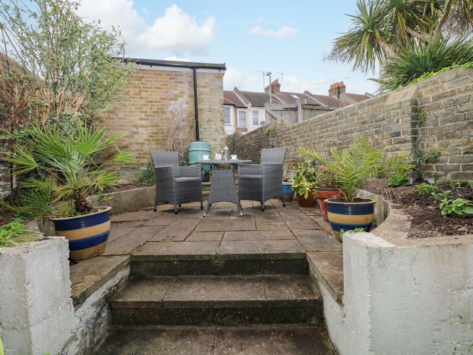 A garden area with a table and chairs at Tickety-Boo in Broadstairs
