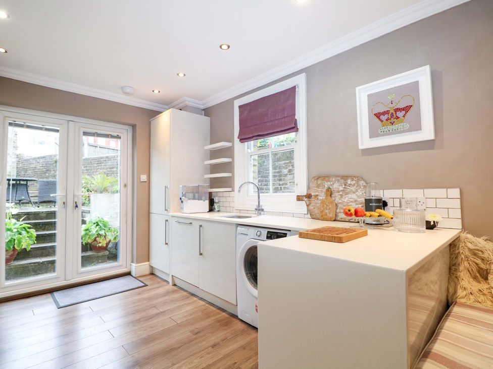 A kitchen with a washing machine and sink at Tickety-Boo in Broadstairs