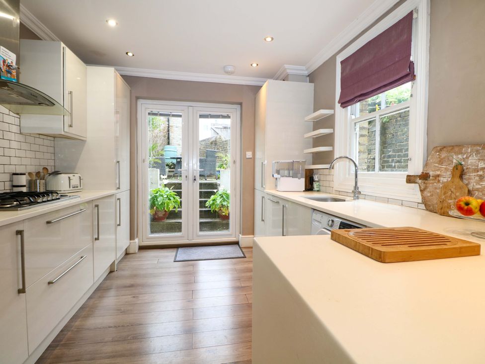 A kitchen with appliances and a view to the garden at Tickety-Boo in Broadstairs