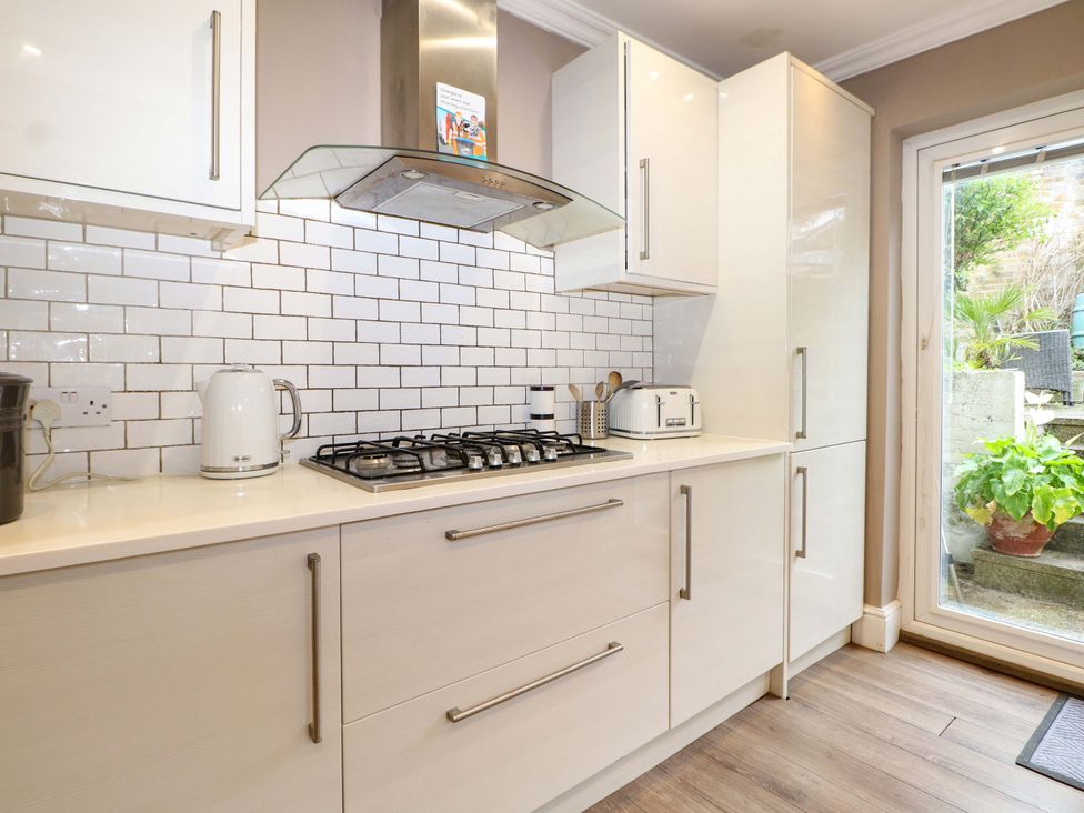 A kitchen with gas stove and kettle at Tickety-Boo in Broadstairs