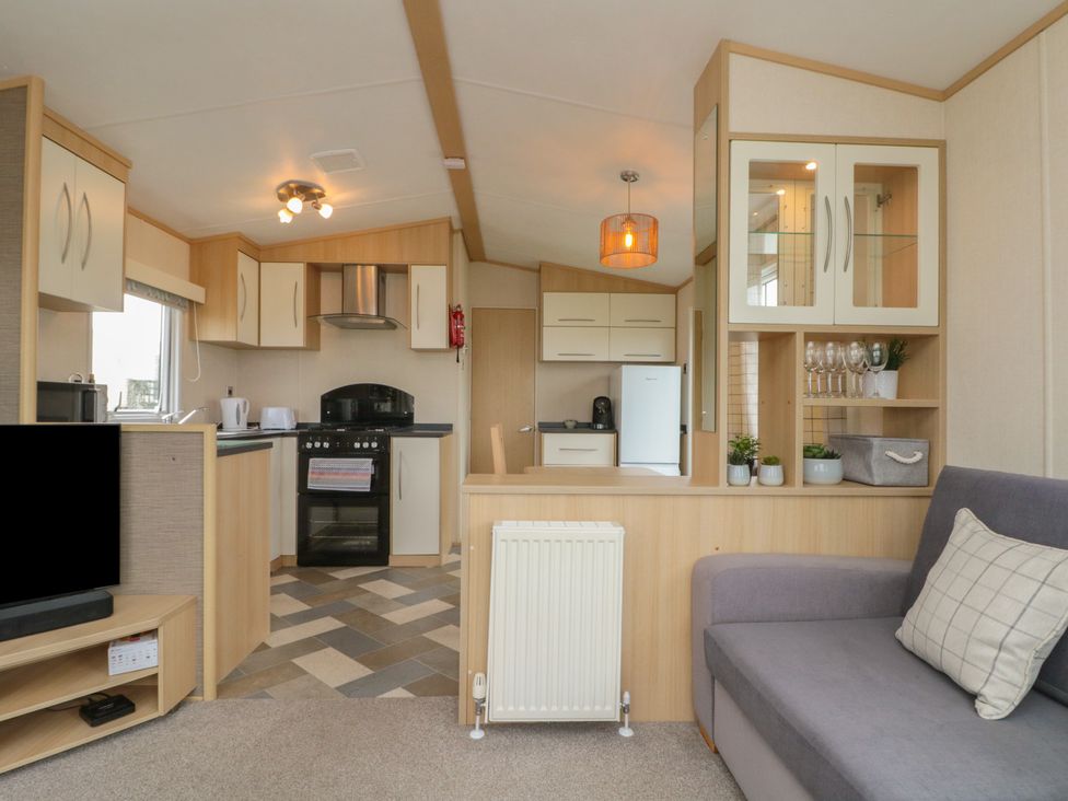A kitchen with a sofa and appliances at 21 Dunlin Dell Flamborough