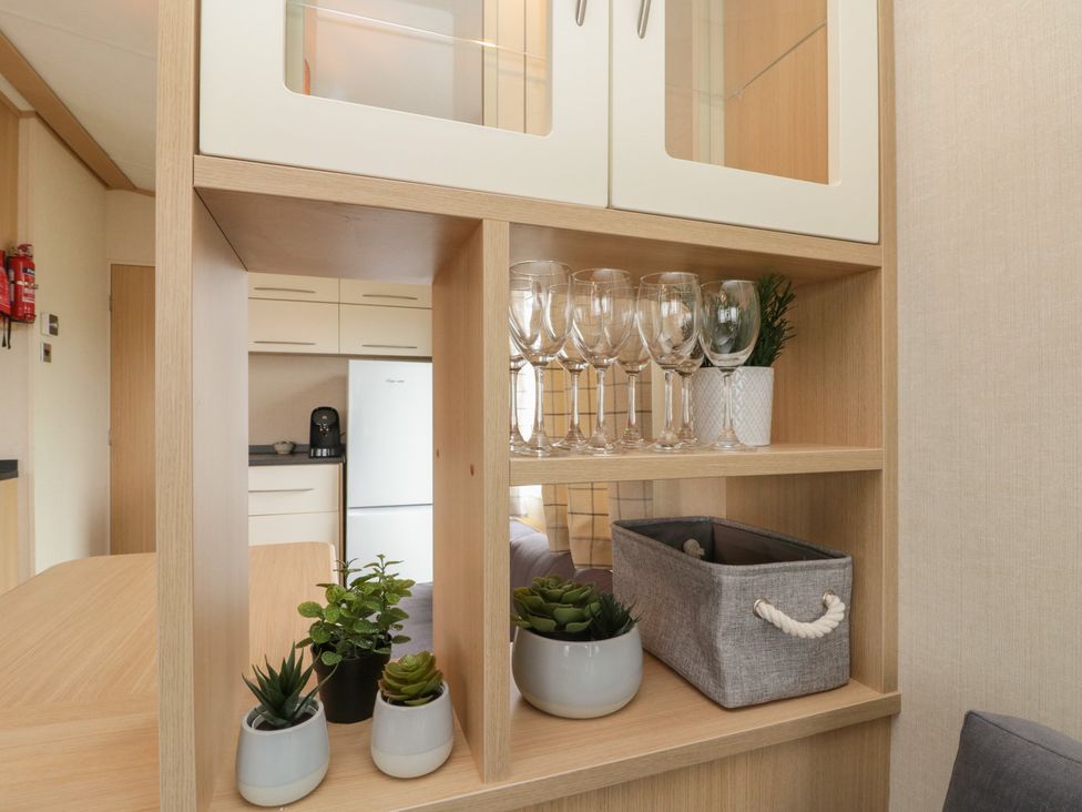 A kitchen with glasses and plants in a cabinet at 21 Dunlin Dell Flamborough