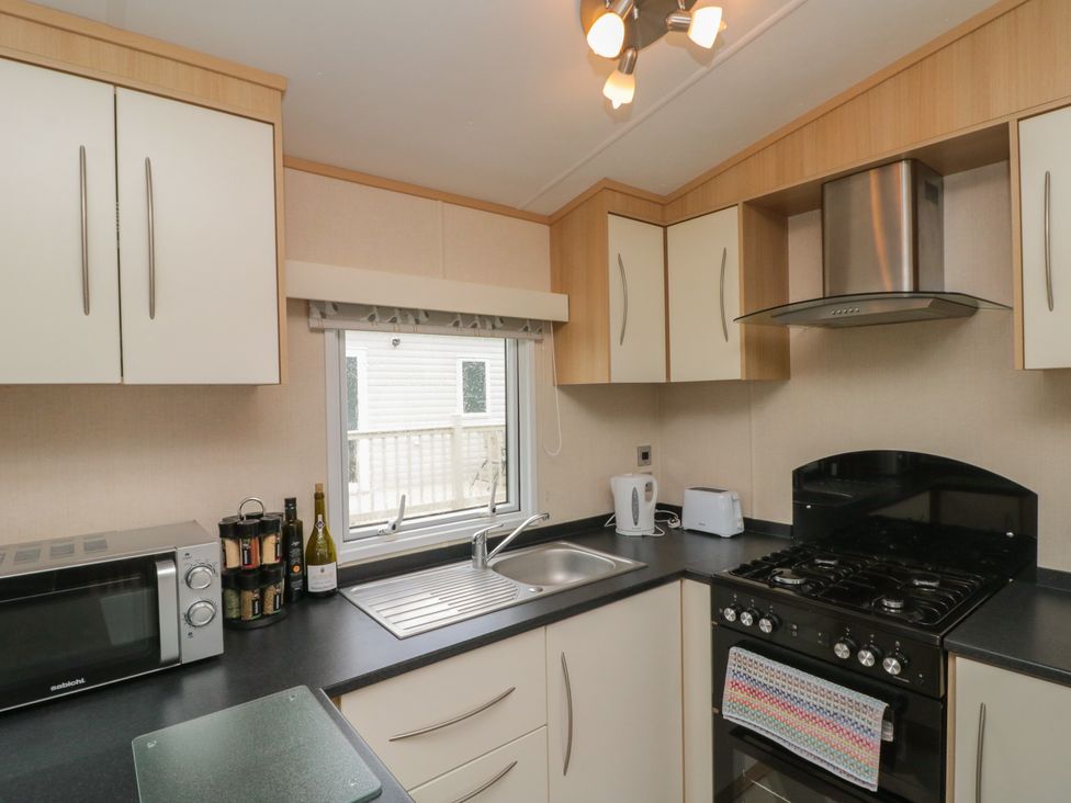 A kitchen with a sink and gas stove at 21 Dunlin Dell in Flamborough