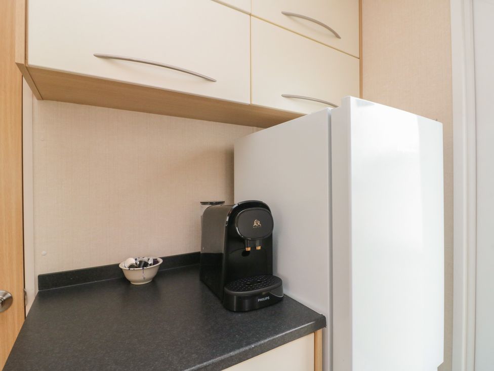 A kitchen with a refrigerator and coffee machine at 21 Dunlin Dell Flamborough