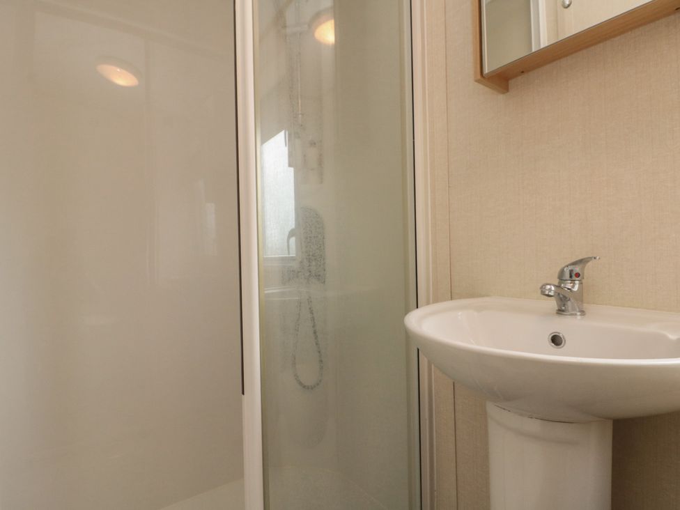 A bathroom with a shower and a sink at 21 Dunlin Dell in Flamborough