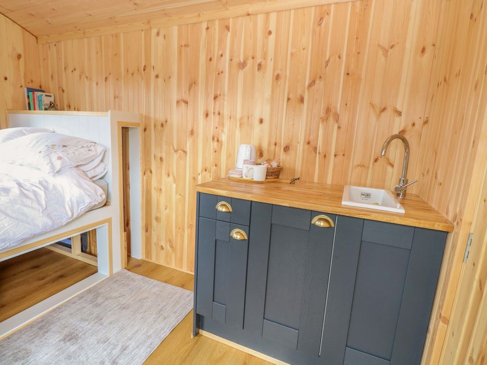 A bedroom with a loft bed and a sink unit at Hazel