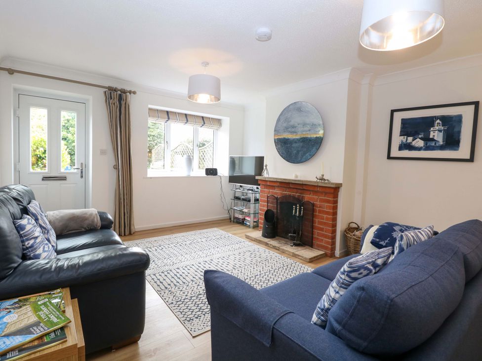 A living room with a television and fireplace at Old Summer in Northrepps near Cromer