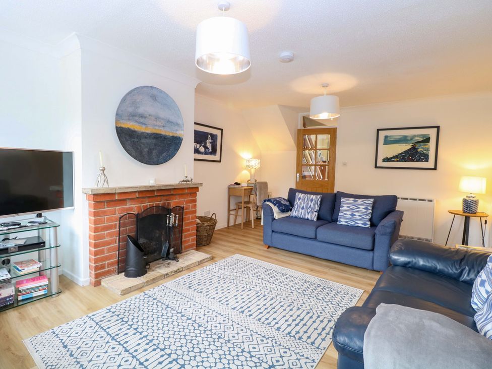 A living room with a fireplace and two sofas at Old Summer in Northrepps near Cromer