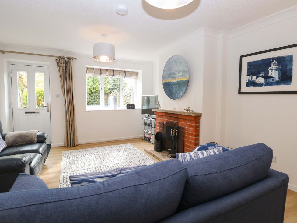 A living room with a fireplace and television at Old Summer near Cromer
