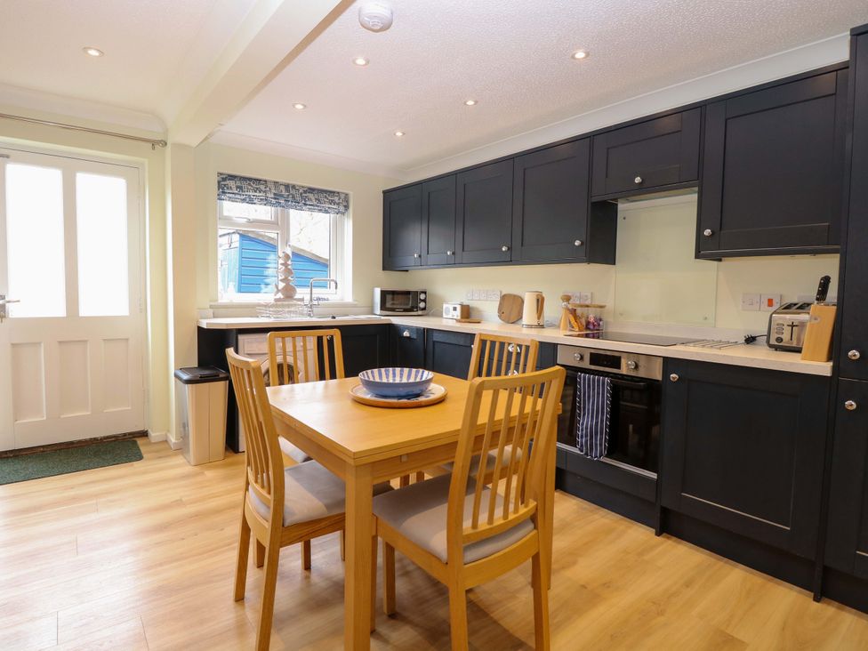 A kitchen with a table and chairs at Old Summer in Northrepps near Cromer