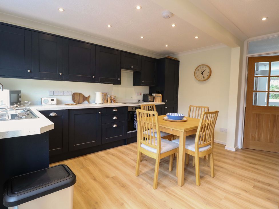 A kitchen with a dining table and chairs at Old Summer Northrepps near Cromer