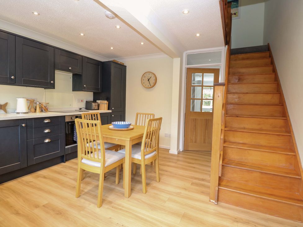 A kitchen with wooden dining table and chairs at Old Summer in Northrepps near Cromer