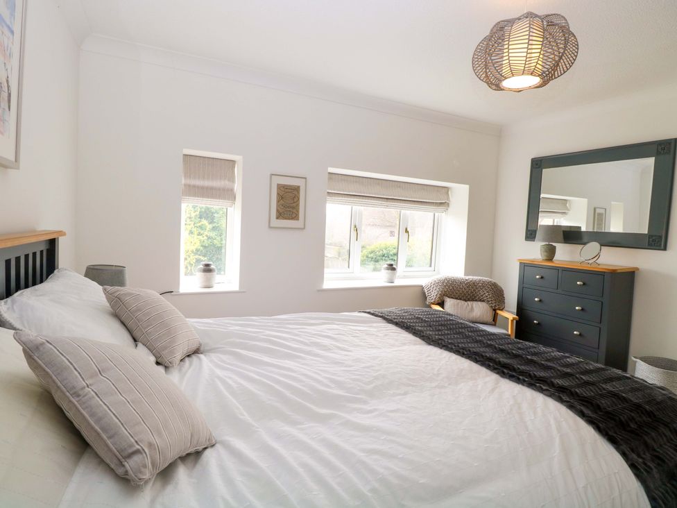 A bedroom with a bed and a chest of drawers at Old Summer near Cromer