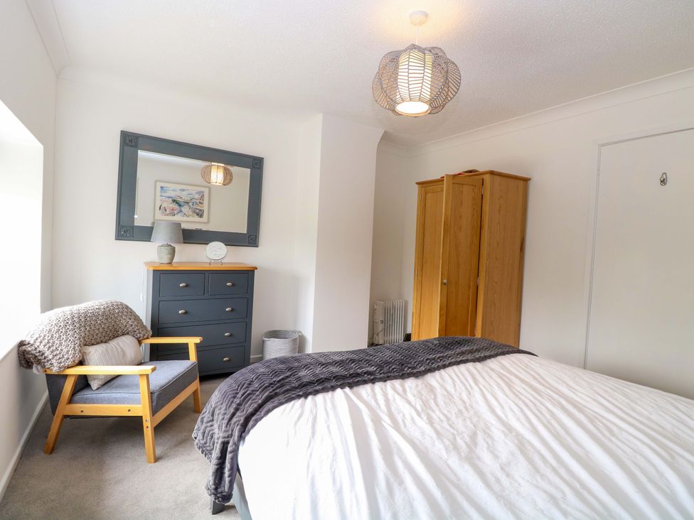 A bedroom with a bed and dresser at Old Summer in Northrepps near Cromer