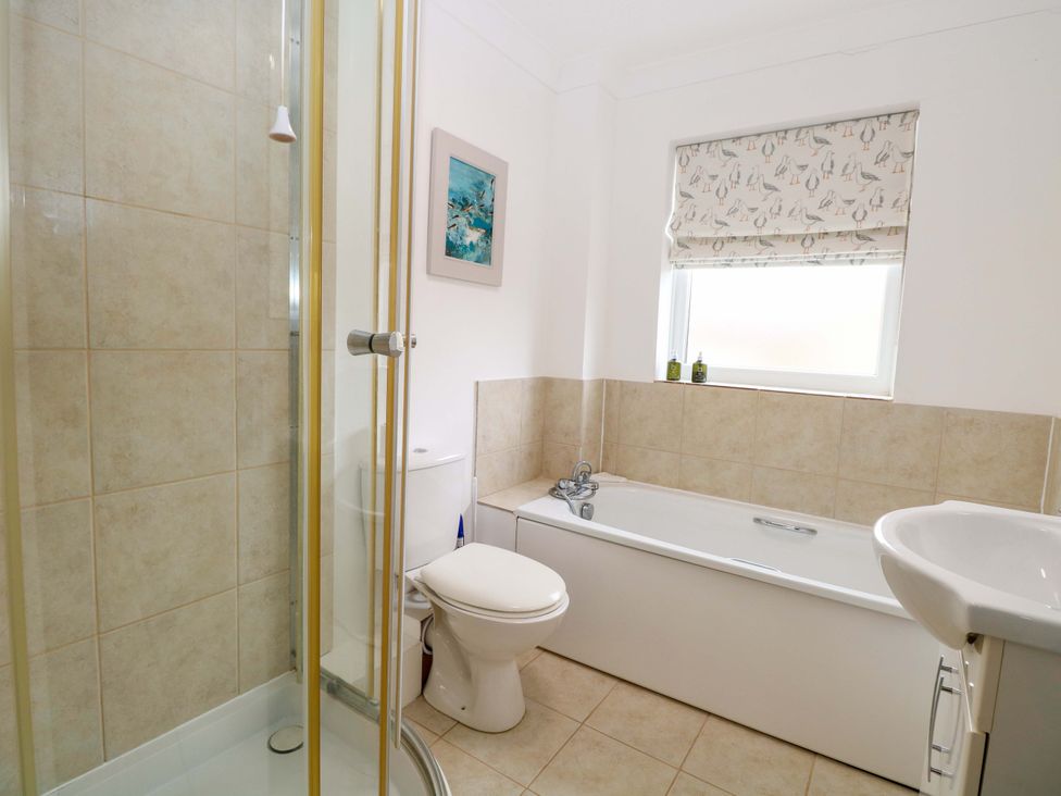 A bathroom with a shower, bathtub, toilet, and sink at Old Summer in Northrepps near Cromer